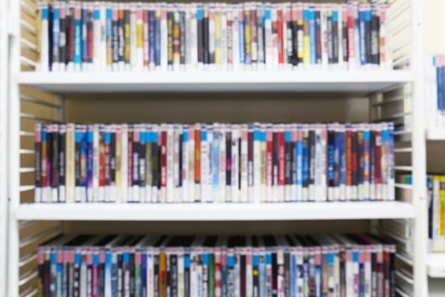 A photo of various limited edition anime Blu-ray box sets and special edition manga volumes displayed on a bookshelf. The items are in pristine condition and are arranged neatly, showcasing their collectible appeal. The focal point is on the detailed artwork and special packaging of the limited editions.