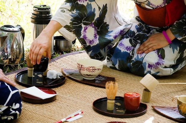 A serene image of a traditional Japanese tea ceremony with participants dressed in kimonos, reflecting the importance of ritual and social harmony in Japanese culture.