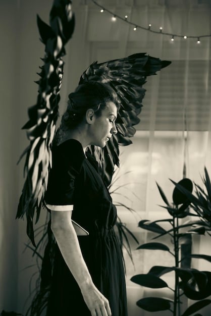 A black and white photo of a vintage J-drama scene showcasing a female character dressed in a traditional kimono, bowing respectfully to a male character in a suit. The focus is on the submissive posture of the woman.