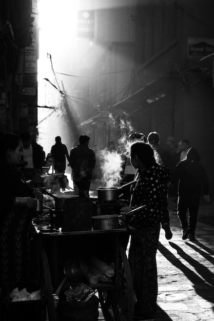 A black-and-white photograph of an early J-drama set, depicting actors in kimonos performing on a stage with basic lighting equipment.