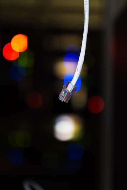 A close-up view of a modern router with blinking lights, with cables connected to it. The background is slightly blurred to keep focus on the router.