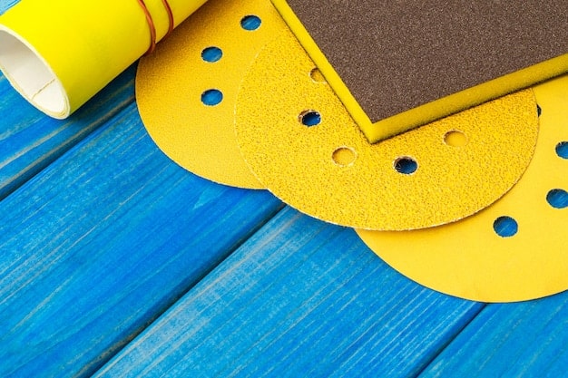 A close-up of various grades of sandpaper laid out next to sanding blocks and a detail sander. The sandpaper is clearly labeled with grit numbers. In the background, you can see cans of primer and sealant, providing a comprehensive view of the tools needed for prop finishing.