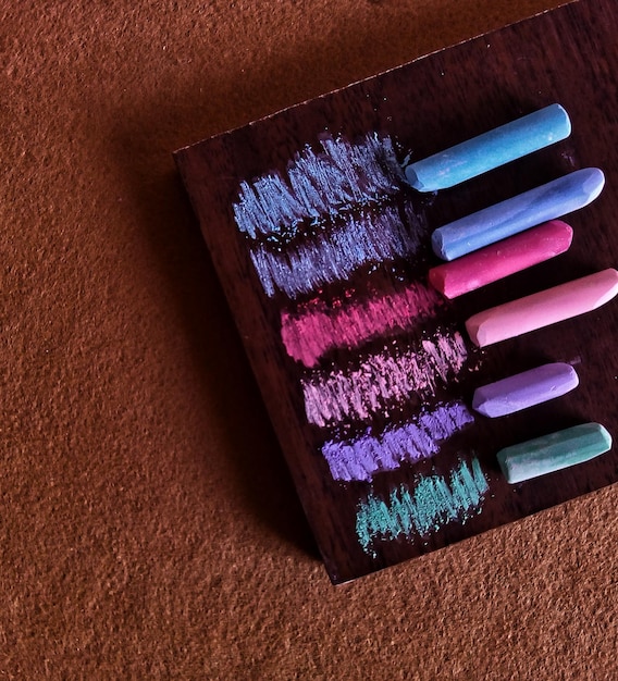 Close-up shot of various body paint products, showing different colors, textures, and brands commonly used in cosplay body painting.