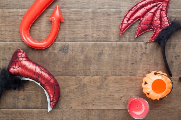 A close-up shot of a variety of inexpensive cosplay materials laid out on a table. There are craft foam sheets, thrift store fabrics, discount bin accessories, and basic tools such as scissors and glue guns. The materials are organized and color-coordinated, suggesting thoughtful planning.