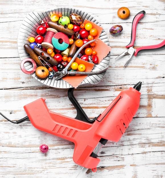 Several cosplay repair tools neatly arranged on a workbench, including sewing kit, hot glue gun, various adhesives, sandpaper, and cutting tools. Labels identify each tool and its common uses in cosplay repair.