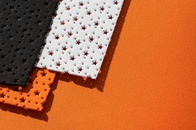 A close-up shot of various thermoplastic sheets and pre-cut EVA foam pieces on a workbench. Tools like heat guns, cutting mats, craft knives, and sanding blocks are neatly arranged around the materials, showcasing a typical armor-building setup.