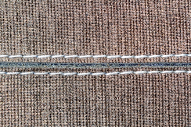 A detailed photograph showing several different hand stitches on a piece of fabric, each labeled for clarity. The stitches include running stitch, back stitch, blind hem stitch, and slip stitch.