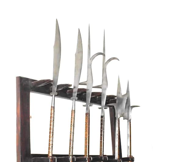 A finished cosplay prop weapon, such as a sword or staff, displayed on a stand, showcasing a smooth, vibrant paint job and a protective sealant layer that gives it a professional look.
