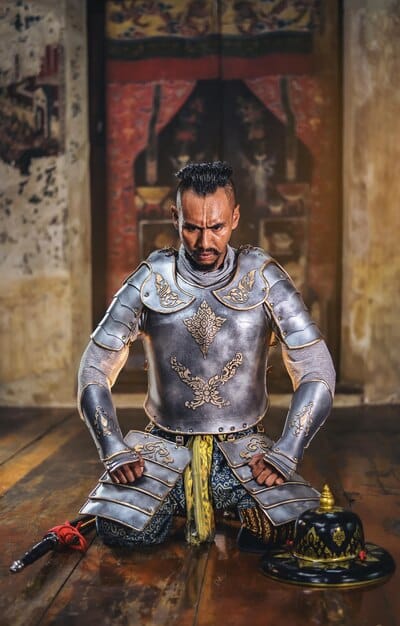 A cosplayer demonstrating the flexibility of a finished Worbla armor chest piece, bending slightly to show its resilience and proper fitting.